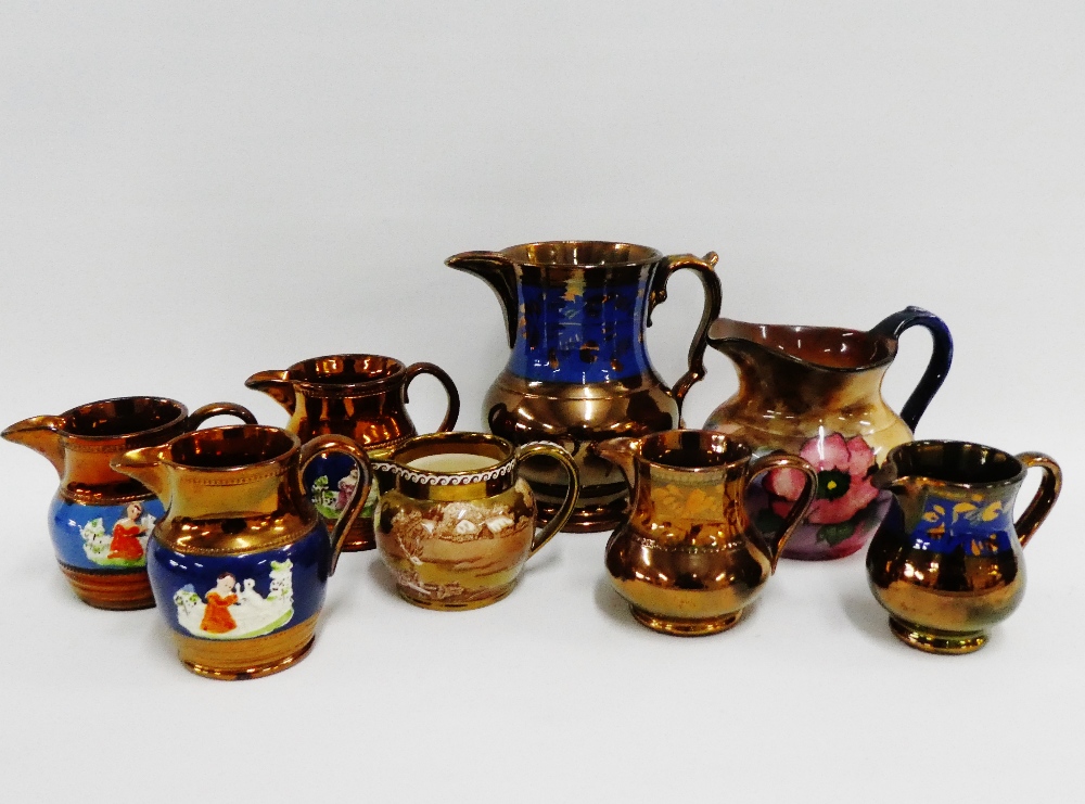 Quantity of copper lustre jugs, (8)