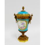 19th century French porcelain ormolu mounted vase with mask head handles and acorn finial to the