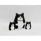 Set of three novelty terracotta black and white painted cat figures, tallest 20cm, (3)