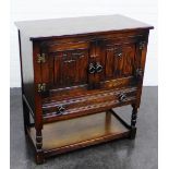 Oak cabinet, the rectangular top over a pair of carved cupboard doors, single long drawer and