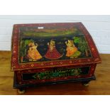 Indian painted wooden box with a sloped hinged lid, painted with figures and a moonlit landscape, 55