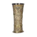 A central European silver-gilt repoussé beaker vase decorated with animals marks illegible, likely