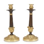 A pair of Louis Philippe gilt and patinated bronze candlesticks second quarter 19th century H: 11