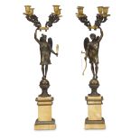 A pair of Charles X gilt and patinated bronze figural four light candelabra aux victoires on Siena