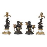Two pairs of 'exotic' figural candlesticks late 19th century H: 11 in. (tallest) PROVENANCE: