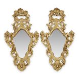 A pair of Venetian carved giltwood cartouche mirrors 20th century H: 34, W: 19 3/4 in. PROVENANCE: