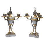 A pair of Louis Philippe gilt and patinated bronze mounted bleu turquin marble three-light