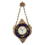 A Napoleon III ormolu mounted porcelain wall clock circa 1880 The round face with Roman chapters and