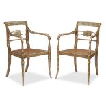 A pair of Regency polychrome decorated caned armchairs second quarter 19th century The curving