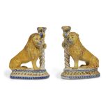 A pair of French faience candlesticks in the form of lions possibly 17th/18th century In the form of