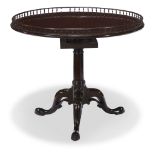 A George III mahogany galleried tilt-top table circa 1750 The circular top with baluster gallery
