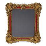 A Surrealist red-painted and carved giltwood mirror after Salvador Dali (Spanish, 1904-1989) 20th