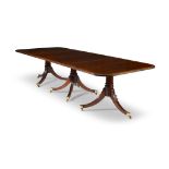 A Regency style satinwood banded mahogany triple pedestal extending dining table late 19th/early