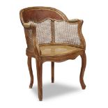 A Louis XV beechwood and tooled leather caned fauteuil de bureau circa 1750 Of typical form with