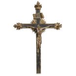 An Italian giltwood crucifix 18th century With painted paper panels and carved wood figure of