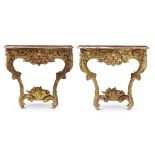 A pair of Louis XV style carved giltwood consoles some elements mid 18th century With later shaped