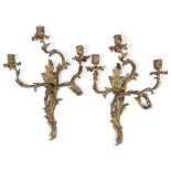 A pair of Louis XV style gilt-bronze three-light wall sconces 20th century H: 21 1/2 in. PROVENANCE: