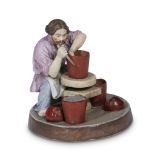 A Russian porcelain group "Peasant Ceramicist Throwing a Pot" Ikonnikov Manufactory, Elizavetino,