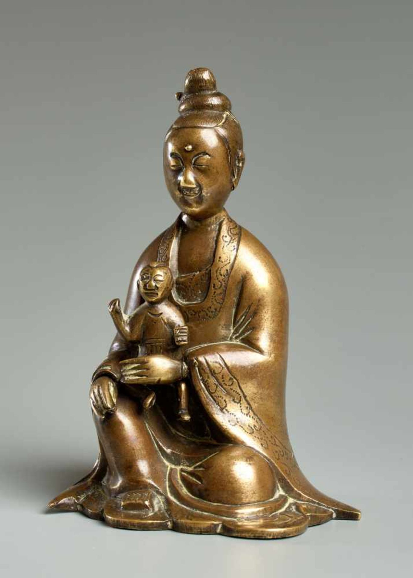THE GODDESS GUANYIN WITH CHILD Yellow bronze. China, 18th cent. Probably the most beloved “deity” in