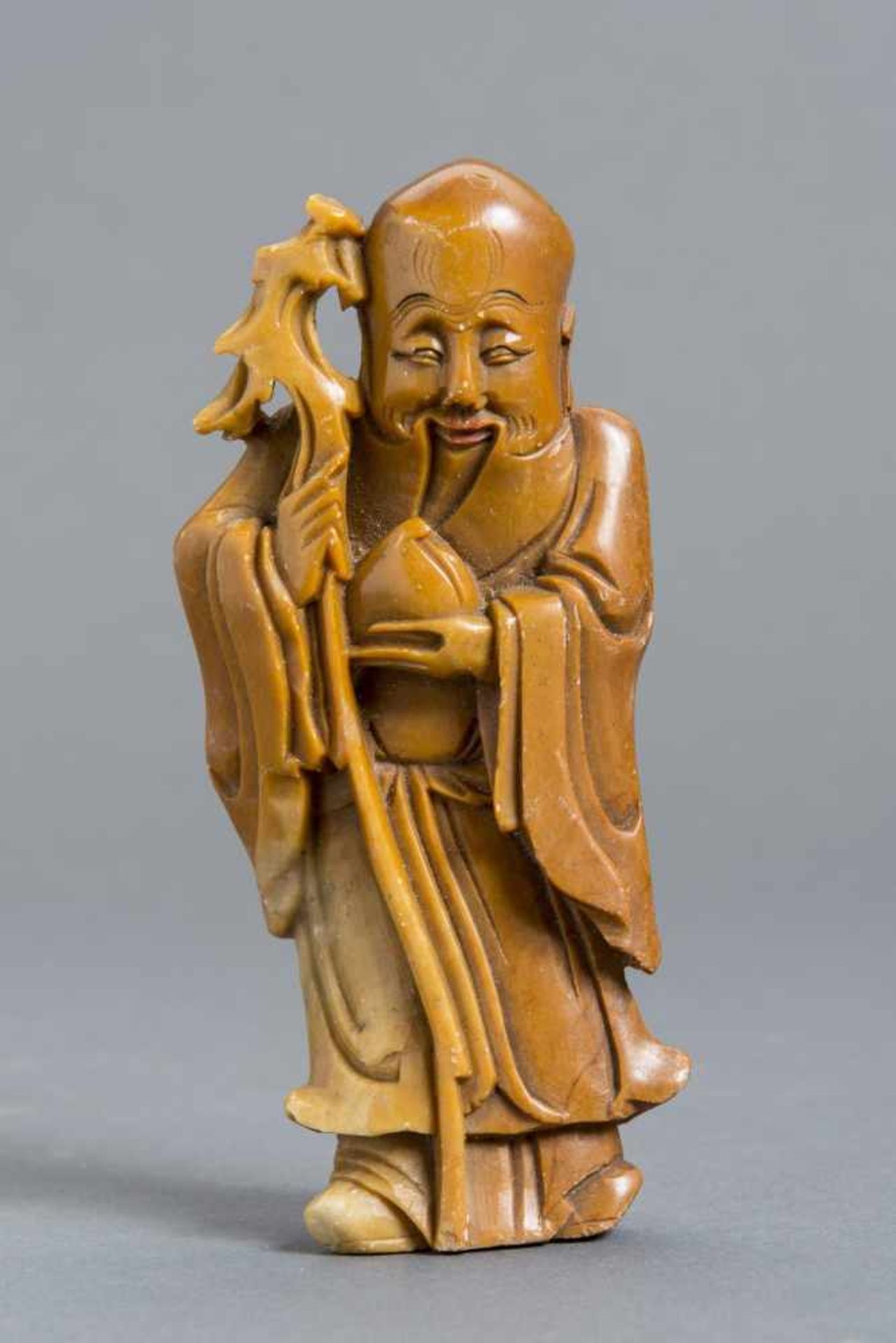 SOAPSTONE CARVING OF A LUCK DEITY Soapstone with some coloring. China, 19th – early 20th cent.HEIGHT