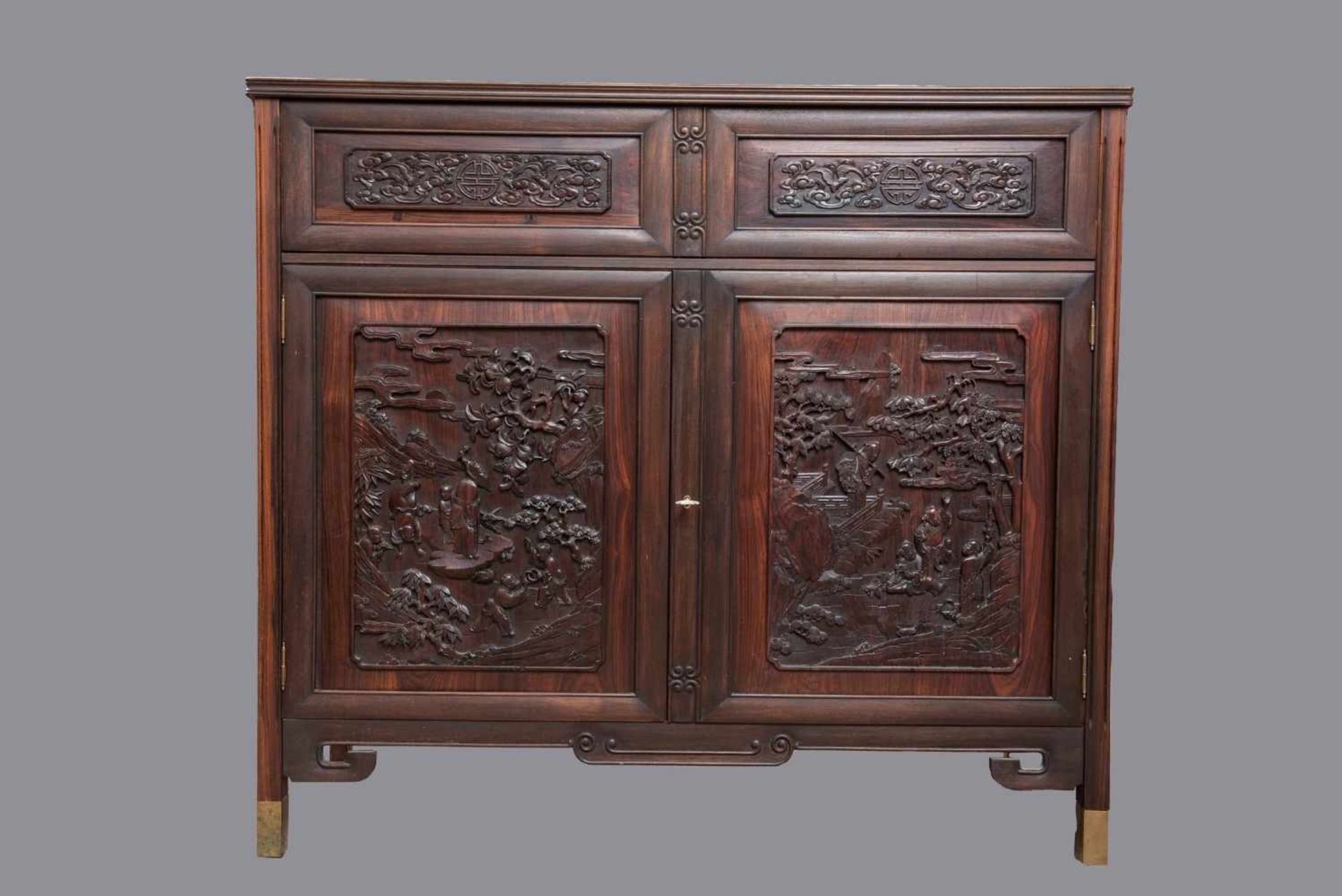 AN ELEGANT DARK HARDWOOD CABINET Hardwood, brass. China, 20th Century Finely carved in relief with