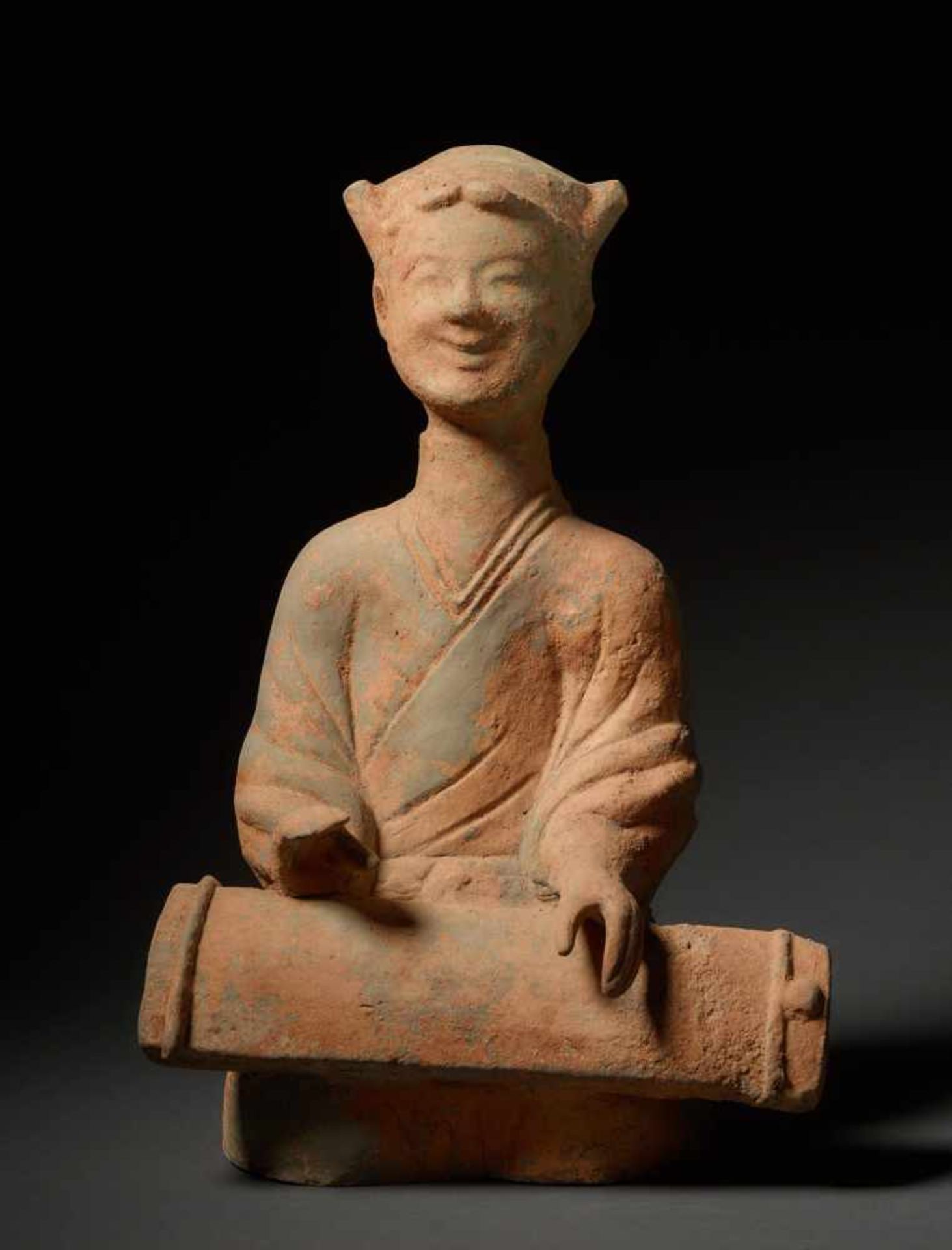 MUSICIAN Terracotta. China, Sichuan, Eastern Han (25 - 220) A girl cowered on the bottom, playing