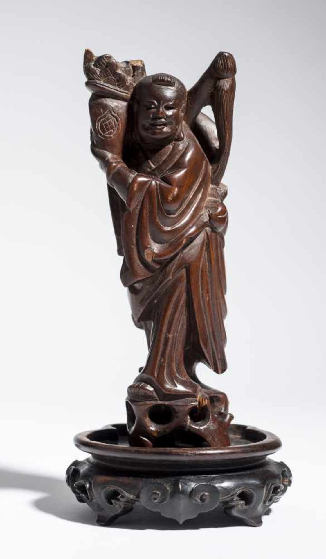 SMALL FIGURINE OF AN IMMORTAL Wood. China, 19th – 20th cent. Possibly one of the “boys of luck”,