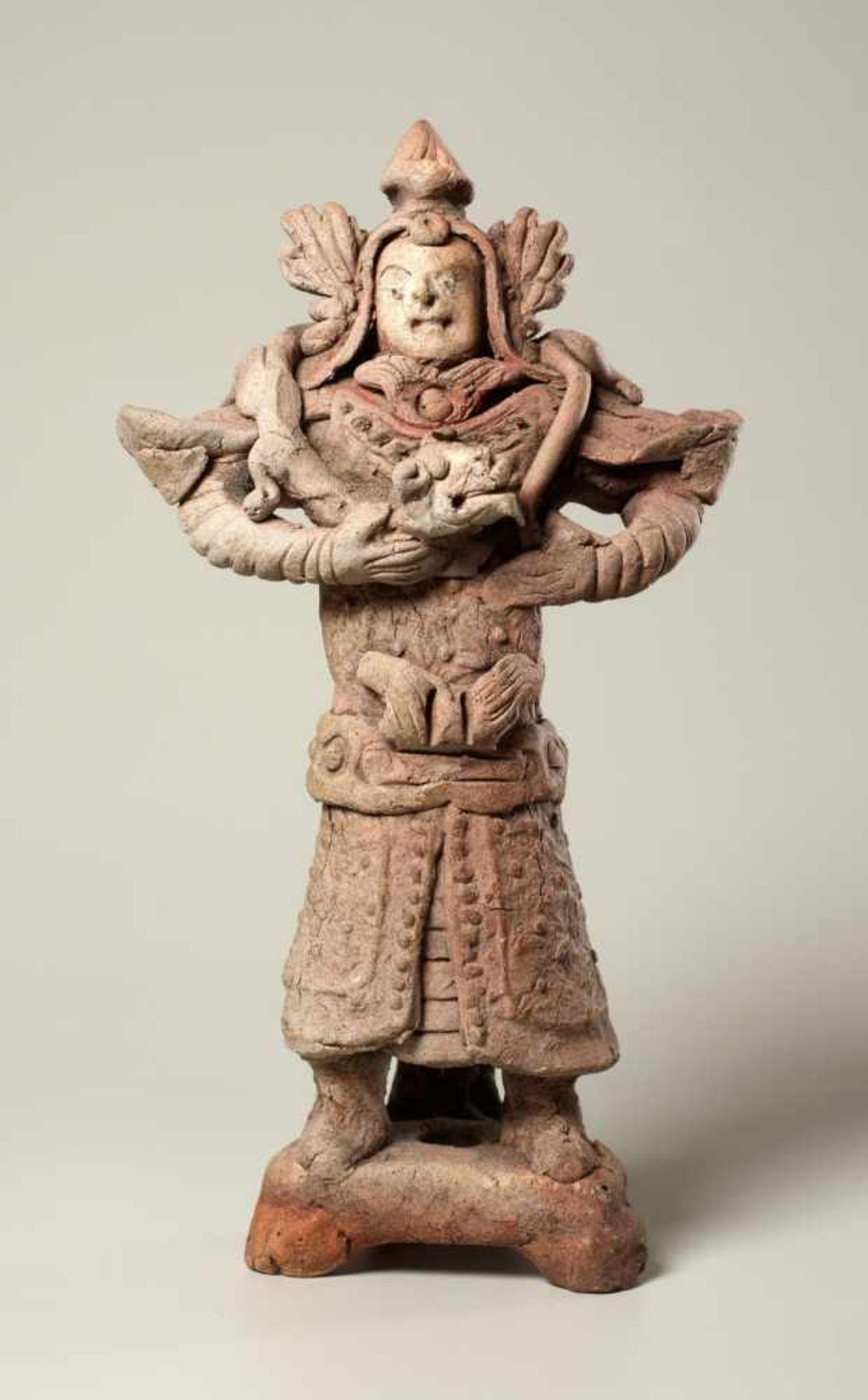 TOMB GUARDIAN WITH SNAKE Terracotta. China, Yuan Dynasty (approx. 14th cent.) Amusingly formed and