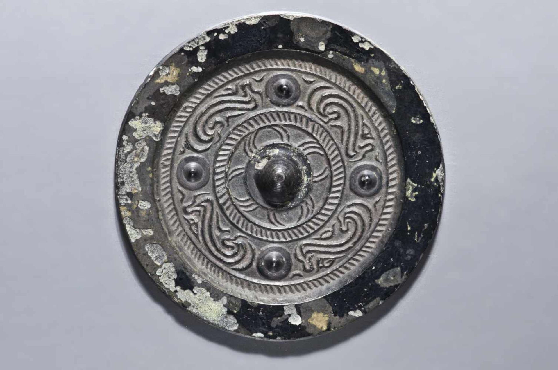 SMALL MIRROR WITH CLOUD DRAGONS Bronze. China, in the style of Han, possibly later Of circular form,