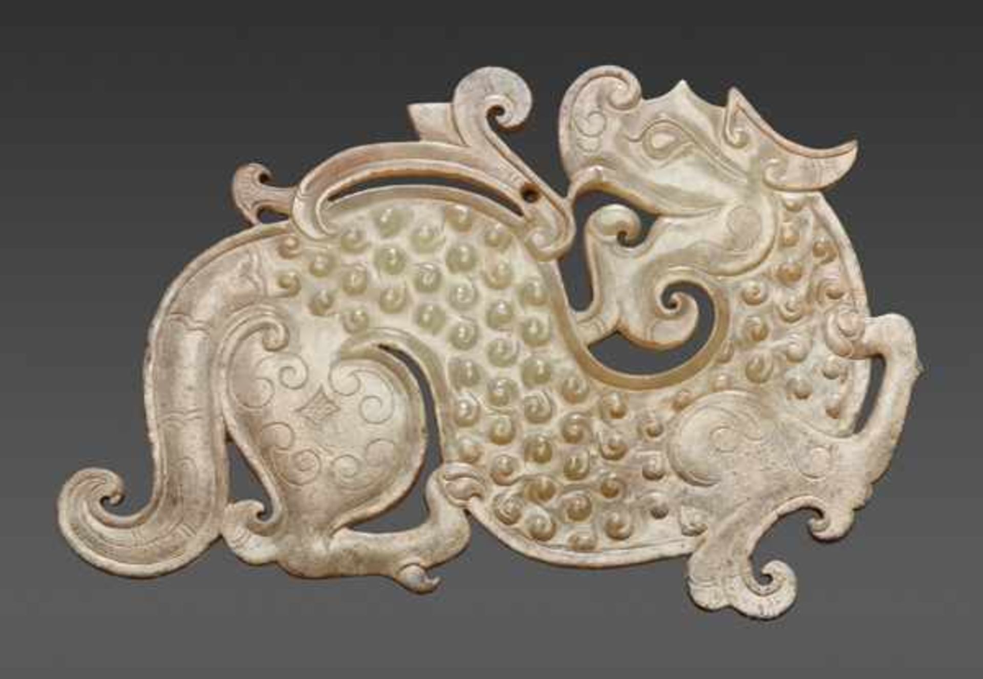 AN EXQUISITE AND RARE TIGER-SHAPED PENDANT IN PALE GREEN JADE WITH FINE INCISED DECORATION Jade,