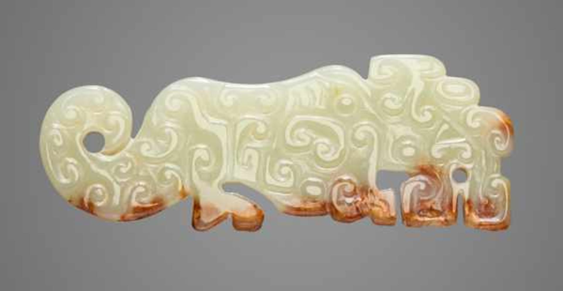 SMALL TIGER-SHAPED ORNAMENT IN TRANSLUCENT GREEN JADE Jade, China. Eastern Zhou, late Spring and
