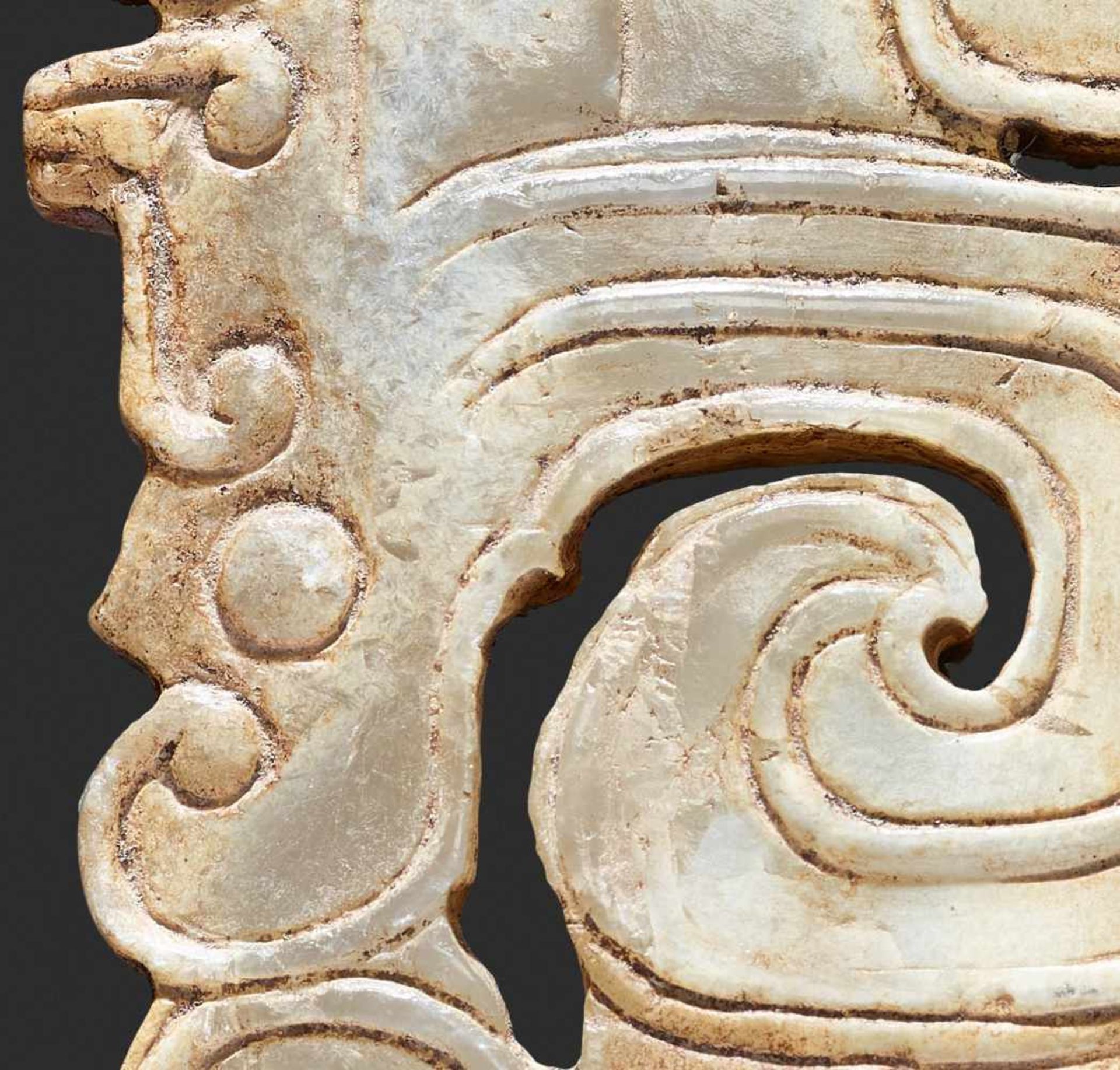 A SCULPTURAL ORNAMENT WITH A COMPOSITE MOTIF OF HUMAN HEADS AND DRAGONS Jade, China. Western Zhou, - Image 10 of 10