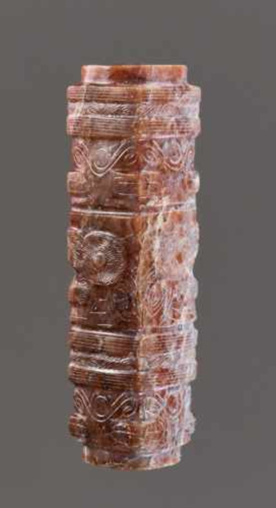 A CONG-SHAPED BEAD WITH MASK MOTIFS AND ADDITIONAL SPIRALLING PATTERNS Jade, China. Late Neolithic