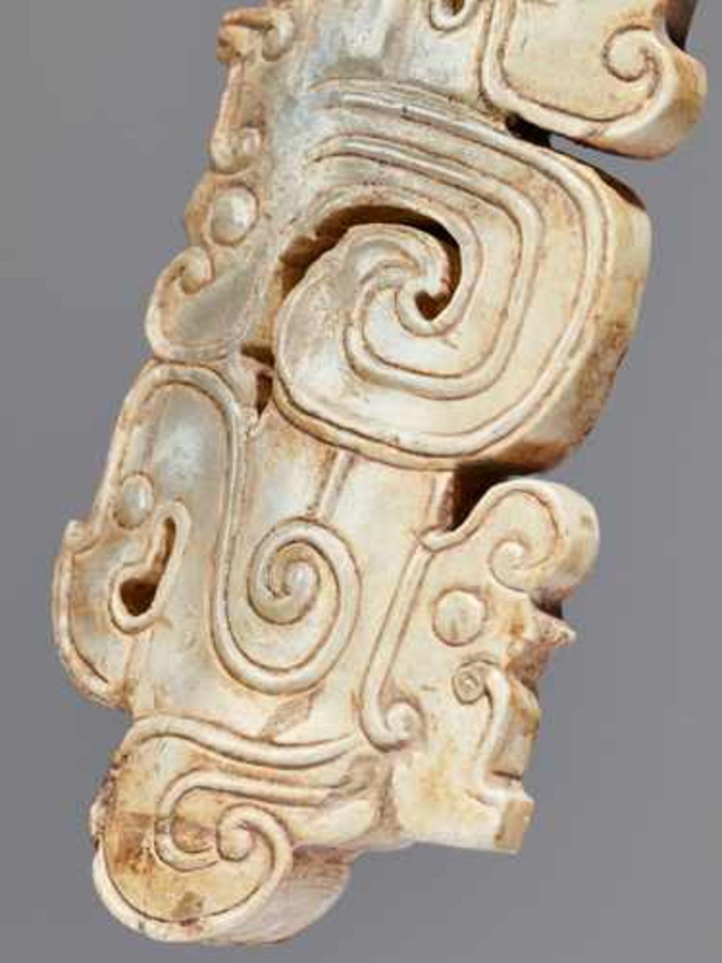 A SCULPTURAL ORNAMENT WITH A COMPOSITE MOTIF OF HUMAN HEADS AND DRAGONS Jade, China. Western Zhou, - Image 8 of 10