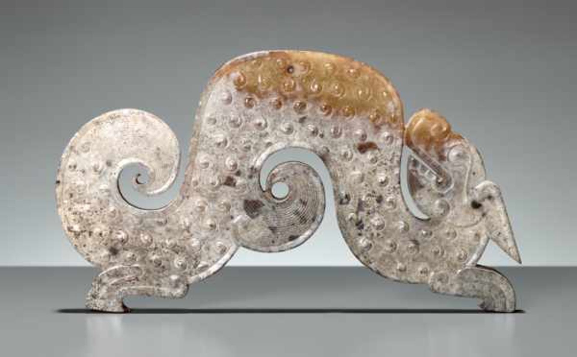 A GRACEFUL S-SHAPED DRAGON WITH FELINE FEATURES AND CURLED APPENDAGES Jade, China. Eastern Zhou, 4th