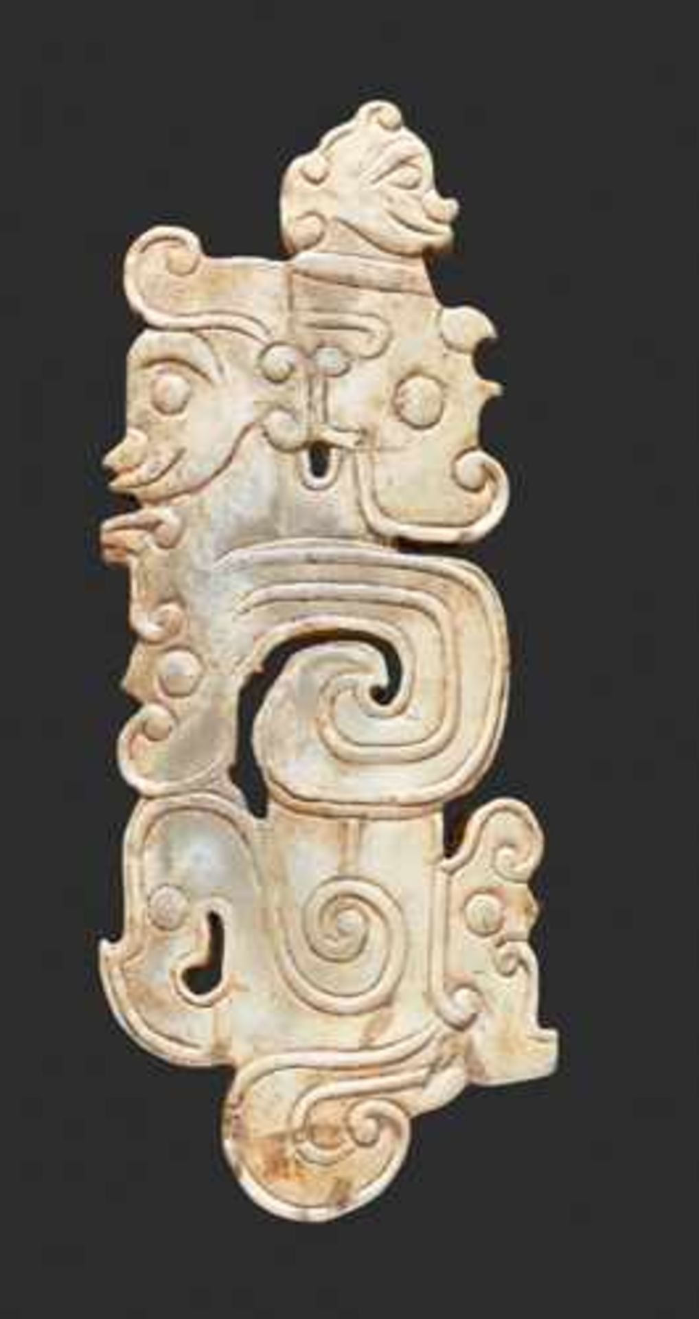 A SCULPTURAL ORNAMENT WITH A COMPOSITE MOTIF OF HUMAN HEADS AND DRAGONS Jade, China. Western Zhou, - Image 3 of 10