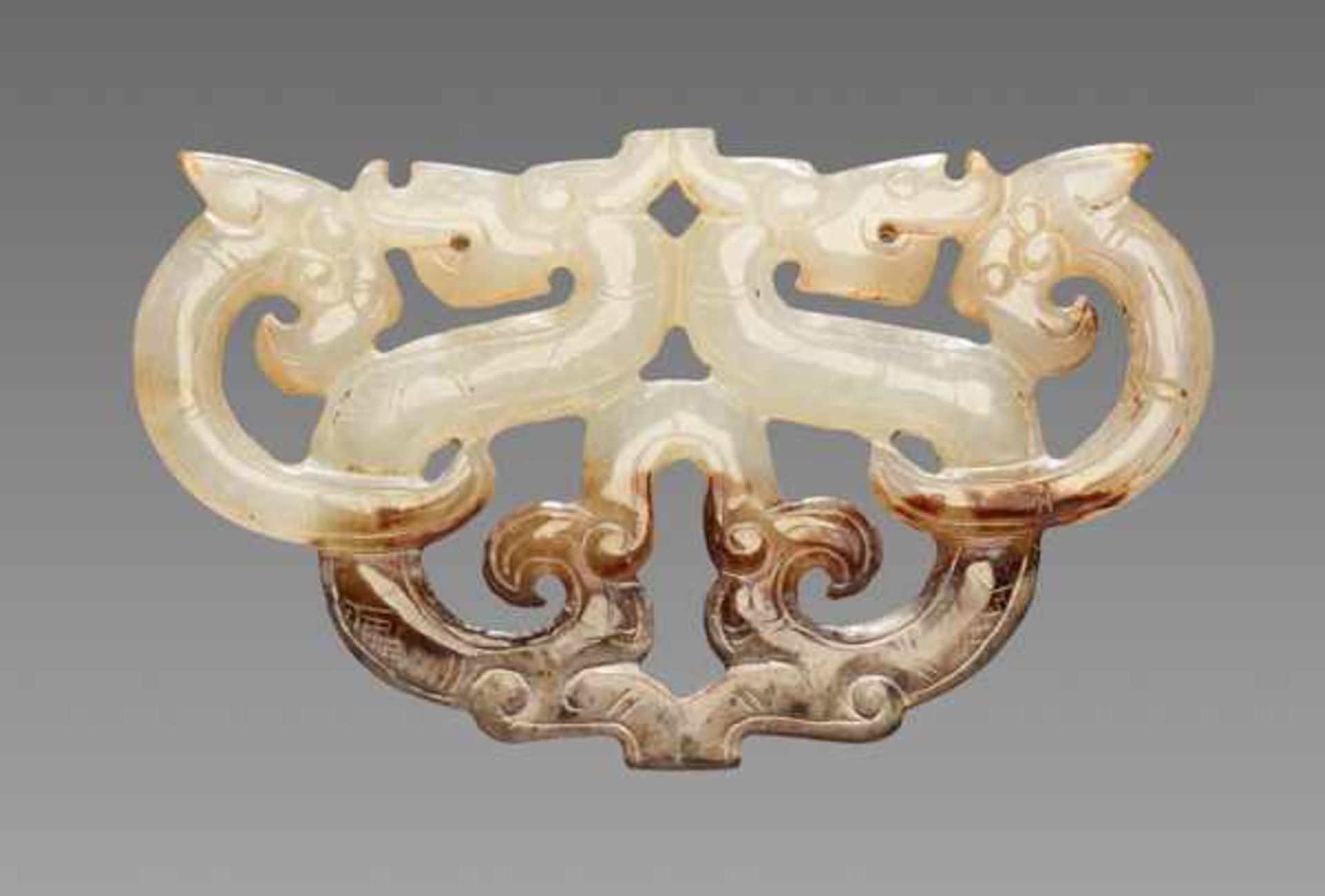 A GRACEFUL ORNAMENT IN OPENWORK WITH DRAGON AND PHOENIX MOTIF Jade, China. Eastern Zhou, Warring