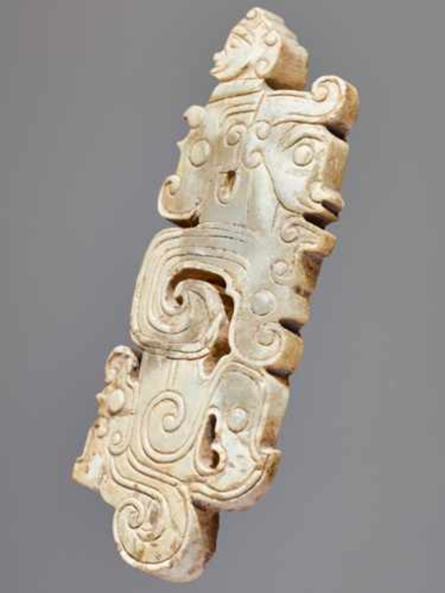 A SCULPTURAL ORNAMENT WITH A COMPOSITE MOTIF OF HUMAN HEADS AND DRAGONS Jade, China. Western Zhou, - Image 6 of 10