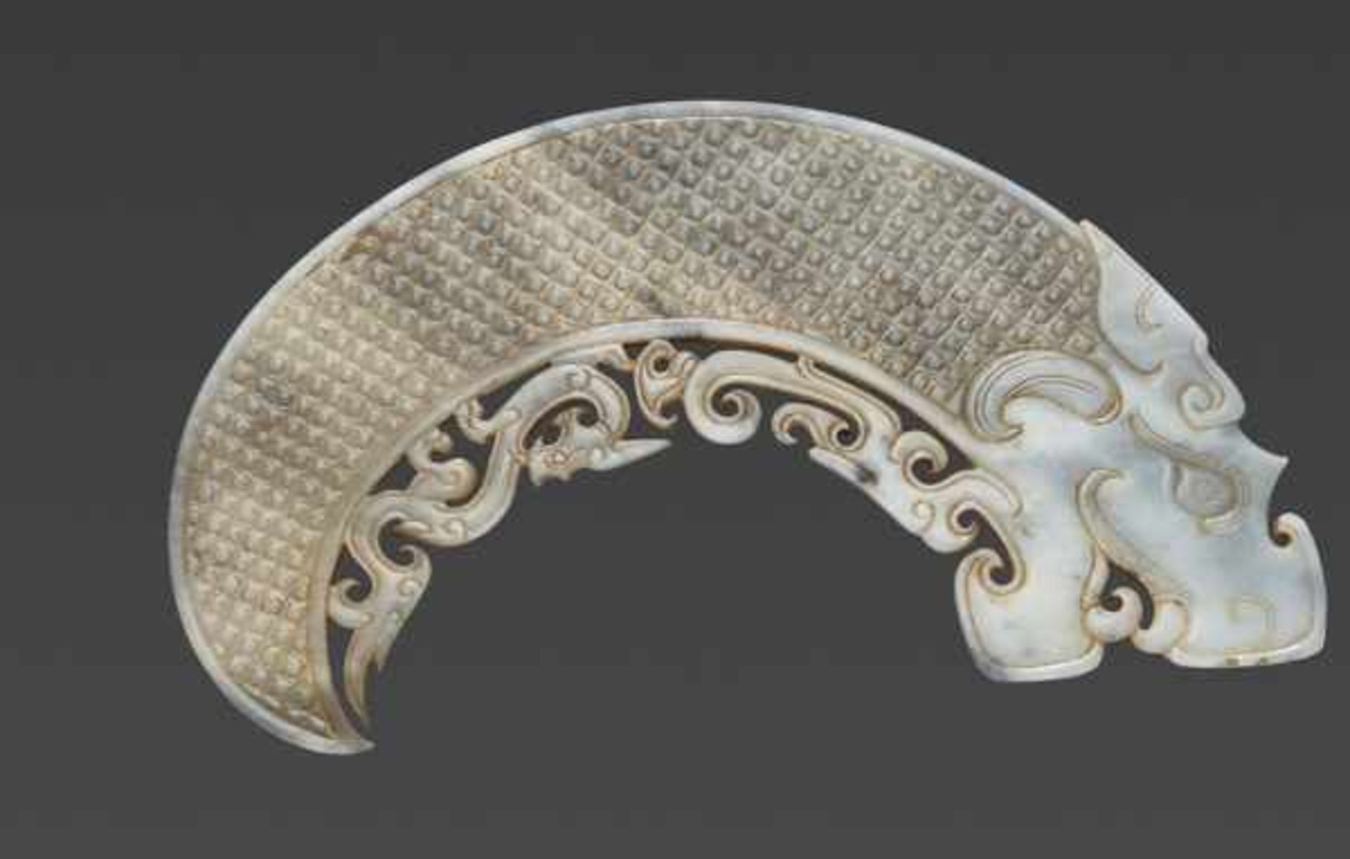 AN EXQUISITE ARCHED DRAGON WITH ORNATE OPENWORK Jade, China. Early Western Han Dynasty, 2nd