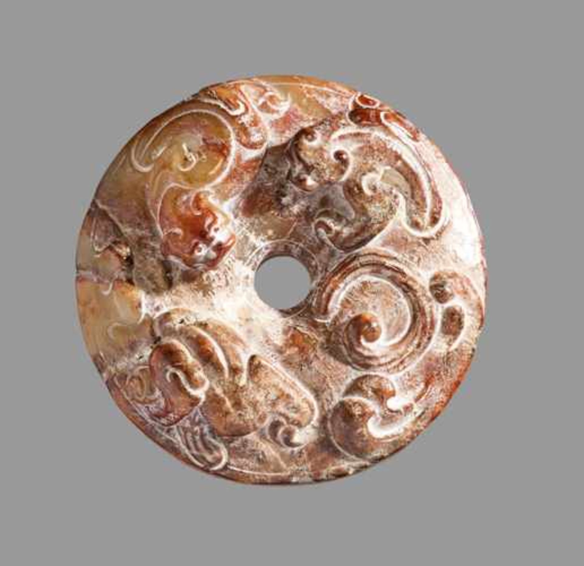 A STRIKING SWORD POMMEL WITH A PAIR OF DRAGONS CARVED IN HIGH RELIEF Jade, China. Western Han, 3rd -