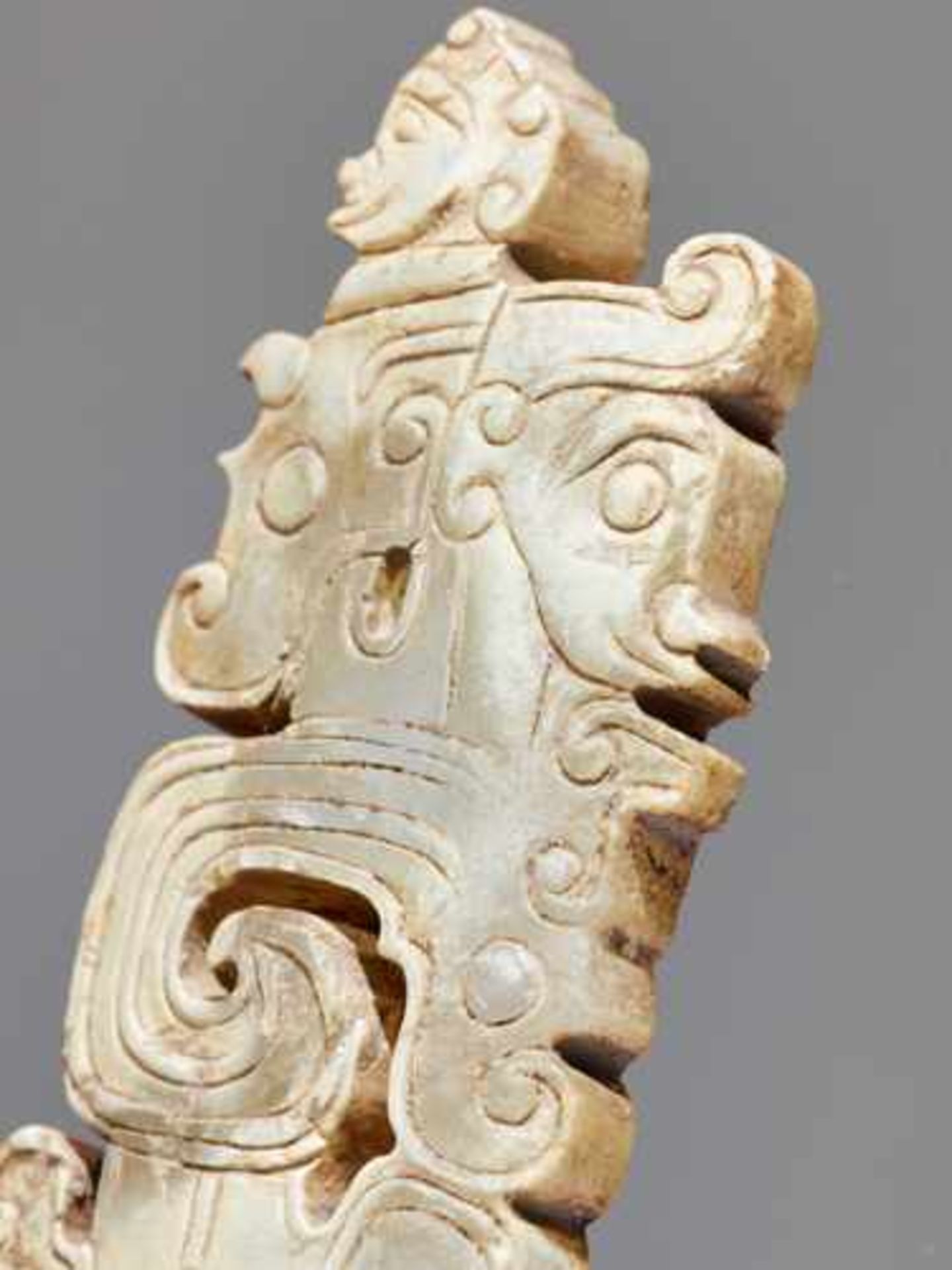 A SCULPTURAL ORNAMENT WITH A COMPOSITE MOTIF OF HUMAN HEADS AND DRAGONS Jade, China. Western Zhou, - Image 4 of 10