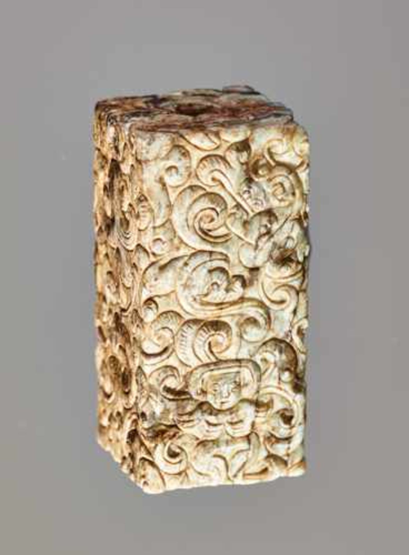 A RARE RECTANGULAR BEAD COVERED WITH AN INTRICATE PATTERN OF IMMORTALS AND MYTHICAL CREATURES