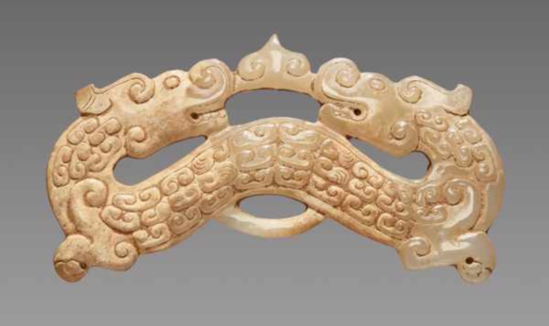 AN UNUSUAL ARCHED DRAGON-SHAPED ORNAMENT IN OPENWORK WITH A FINE POLISH Jade, China. Eastern Zhou,