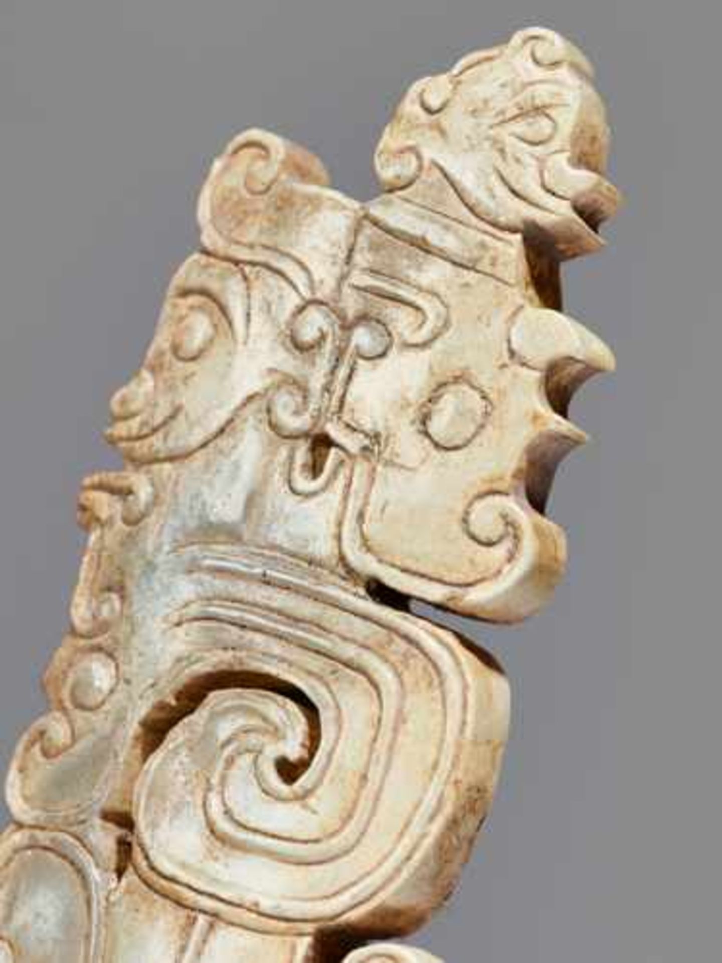 A SCULPTURAL ORNAMENT WITH A COMPOSITE MOTIF OF HUMAN HEADS AND DRAGONS Jade, China. Western Zhou, - Image 7 of 10