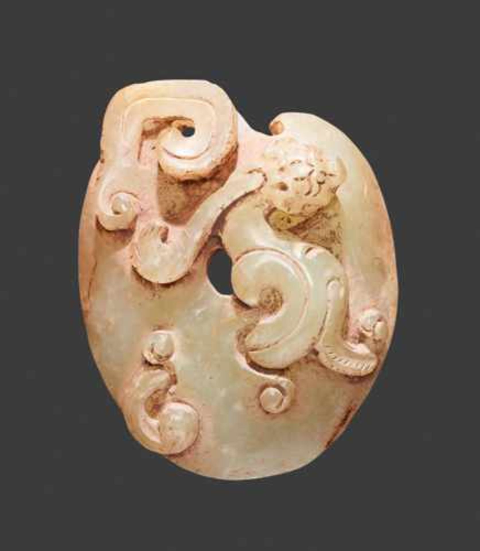 A SMALL LIGHT GREEN JADE PENDANT IN THE SHAPE OF AN ARCHER’S RING WITH A DRAGON IN RELIEF Jade,