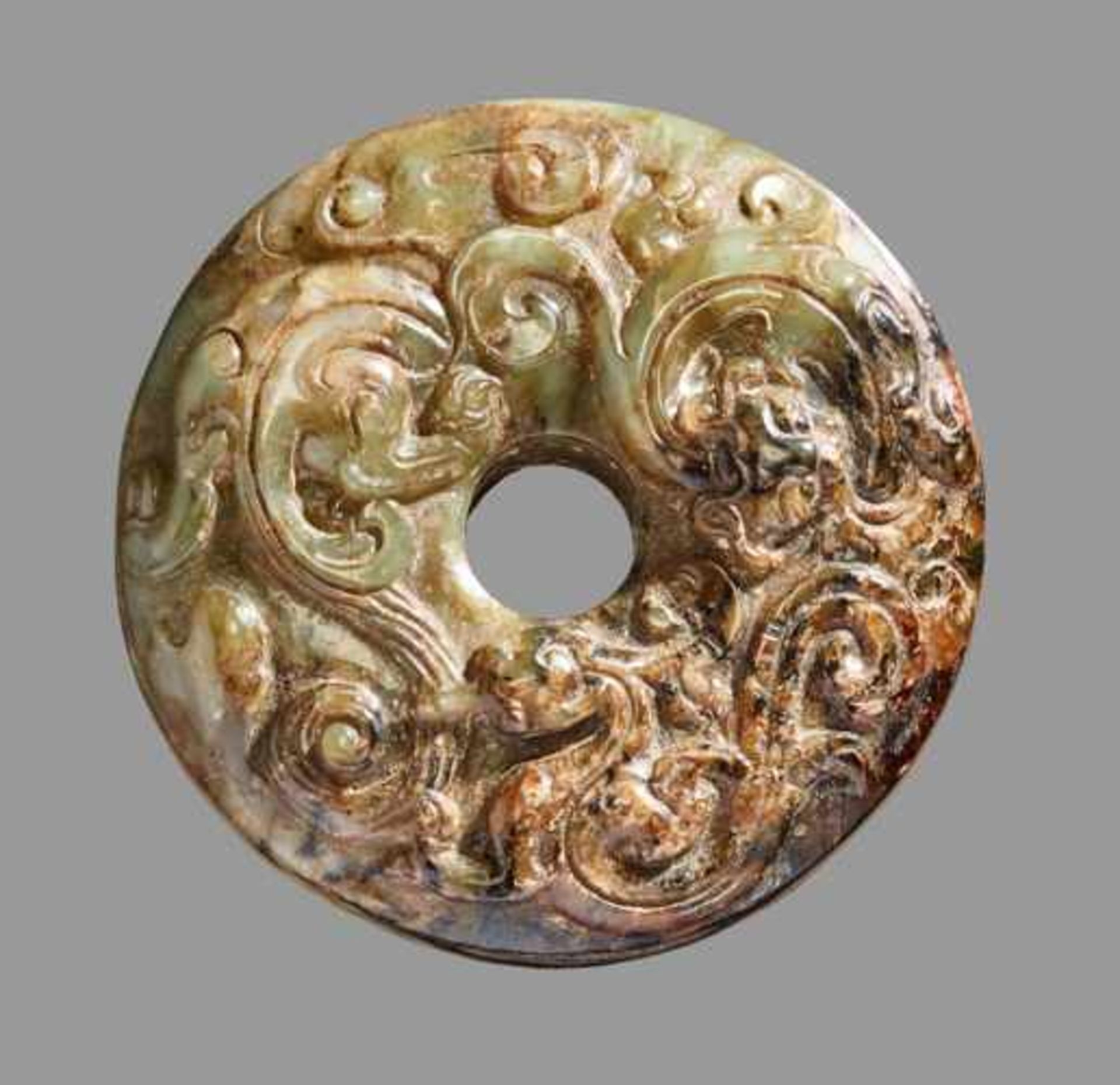 A UNIQUE SWORD POMMEL IN GREEN AND BROWN JADE WITH SCULPTURAL DECORATION OF A DRAGON AND A PHOENIX