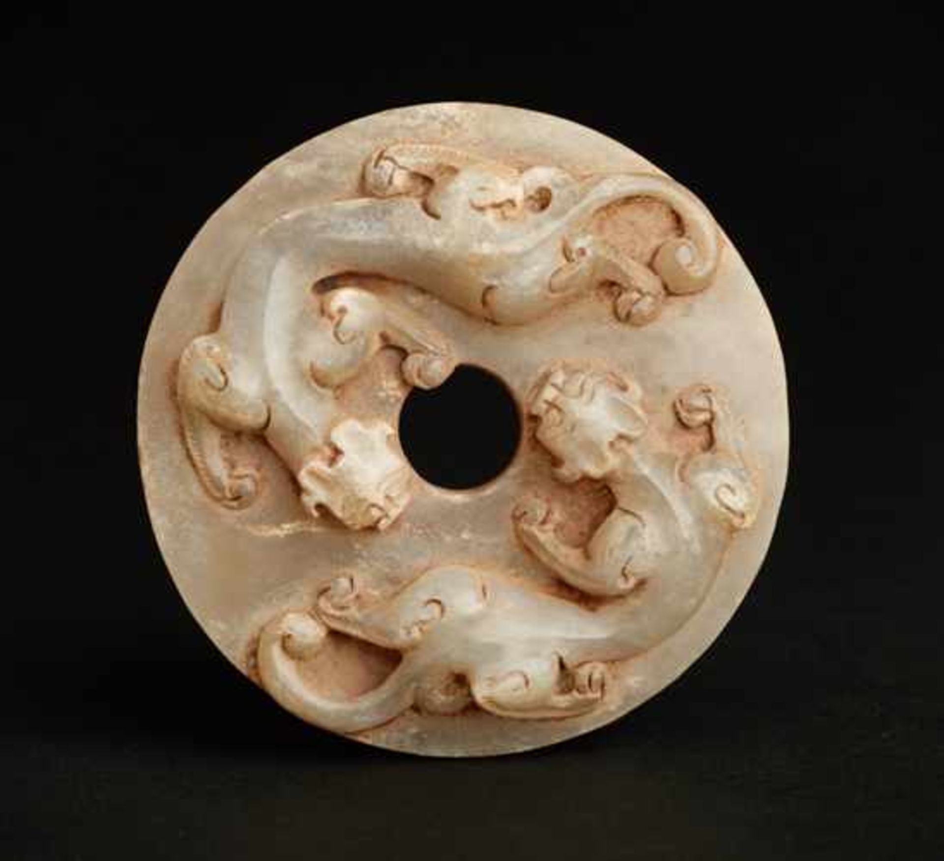 AN IMPRESSIVE WHITE JADE SWORD POMMEL WITH TWO DRAGONS CARVED IN RELIEF Jade, China. Western Han,