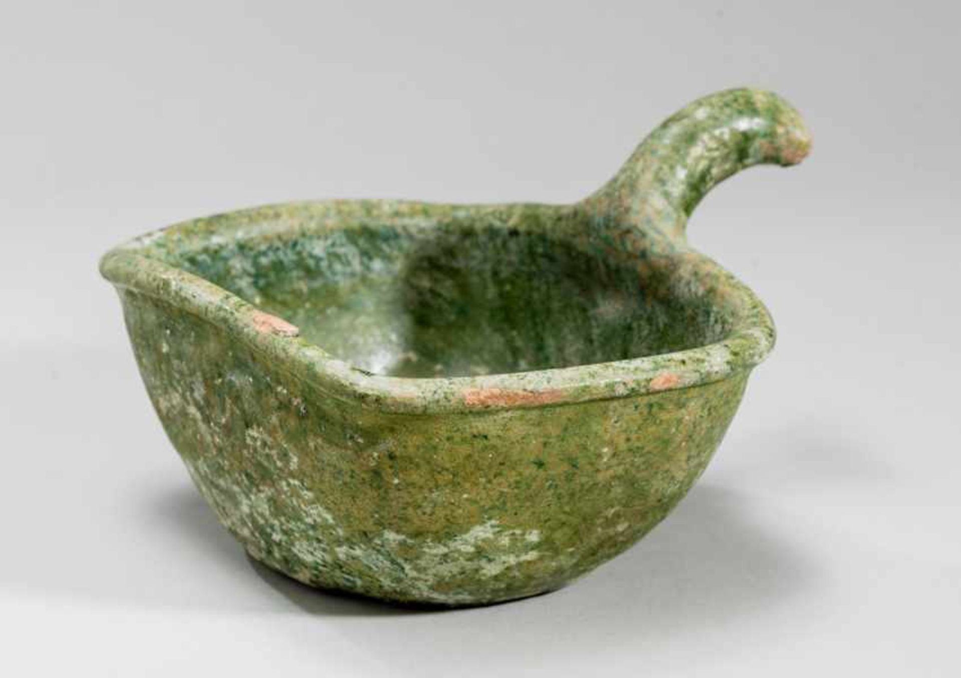 VESSEL WITH HANDLE Glazed ceramic. China, Han dynasty (206 BCE - 220 CE)帶柄容器A - though simple -