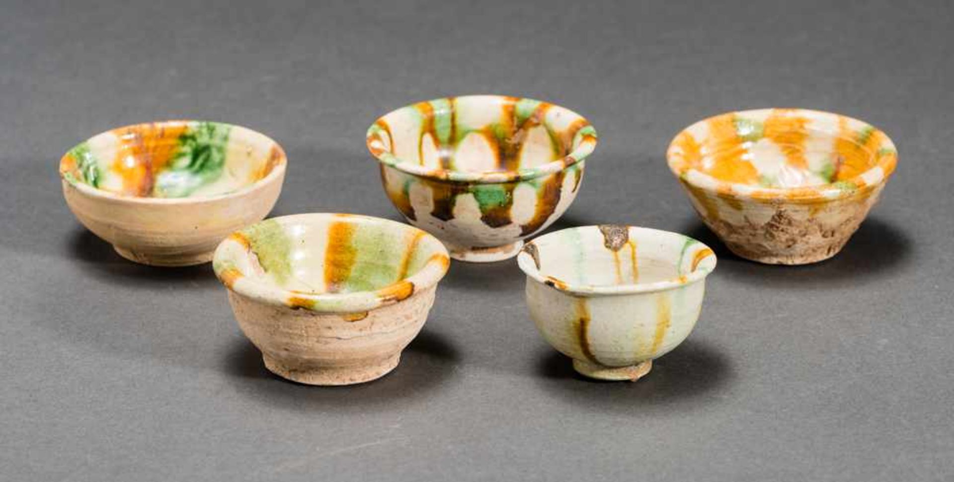 FIVE BOWLS Glazed ceramic. China, Tang dynasty (618 - 907)五隻杯子Small, regularly formed bowls with