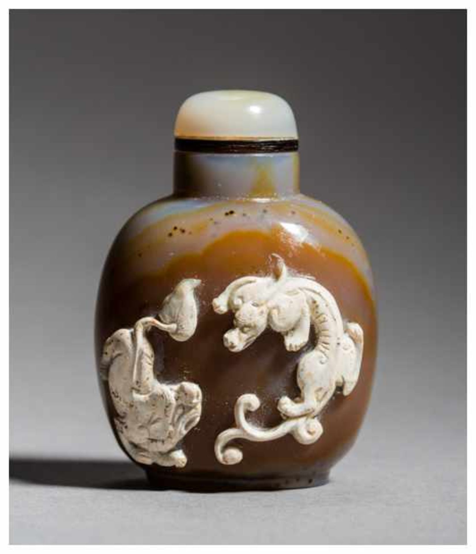 SNUFF BOTTLE WITH DRAGON AND LION Chalcedony. China, 20th centuryThis snuff bottle has a beautiful